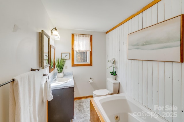 bathroom featuring vanity, a tub, and toilet