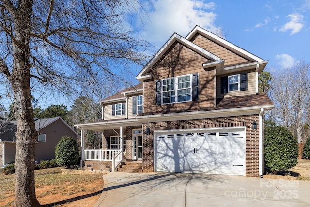 view of front of property with a porch and a garage