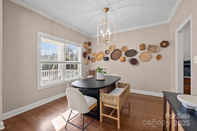 dining area with dark hardwood / wood-style floors, ornamental molding, and a chandelier