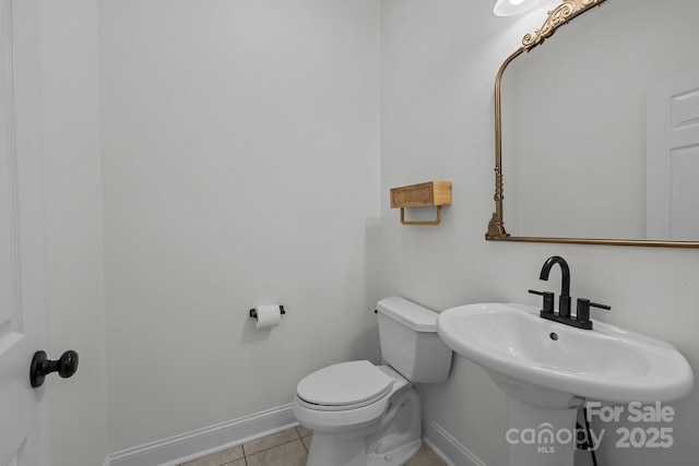 bathroom featuring tile patterned floors, toilet, and sink