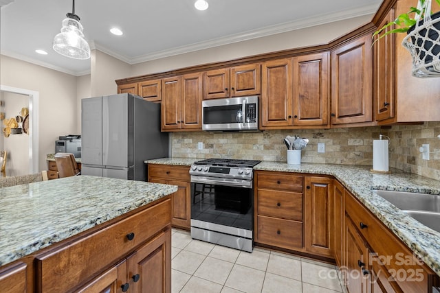 kitchen with light tile patterned flooring, light stone counters, ornamental molding, appliances with stainless steel finishes, and backsplash