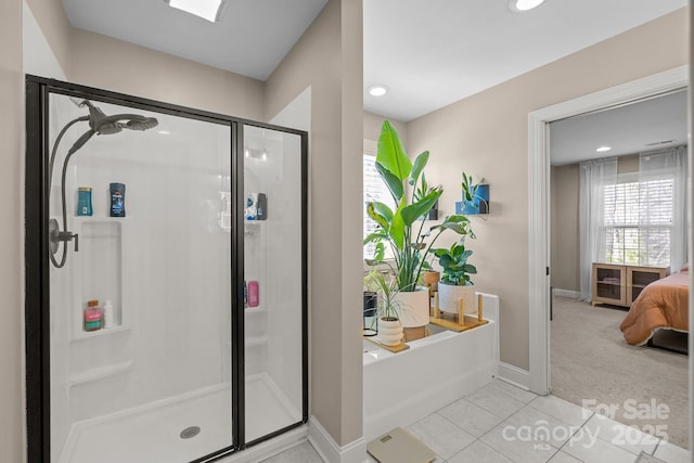 bathroom with separate shower and tub and tile patterned floors