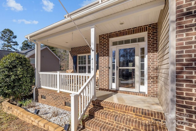 view of exterior entry featuring a porch