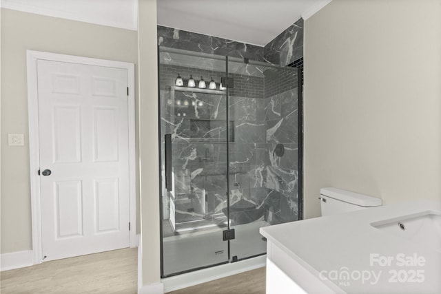 bathroom featuring walk in shower, toilet, and hardwood / wood-style floors