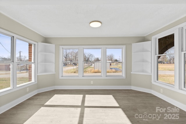 unfurnished sunroom featuring a wealth of natural light