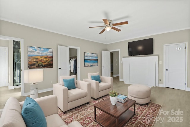 living room with ceiling fan, ornamental molding, and light hardwood / wood-style floors