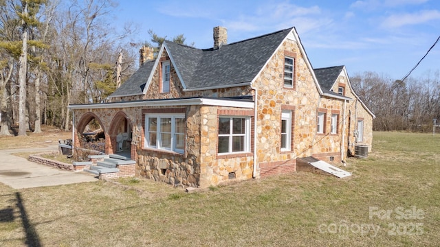 exterior space featuring central AC and a yard