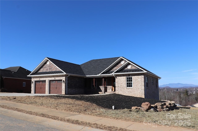 view of front of home featuring a mountain view and a garage