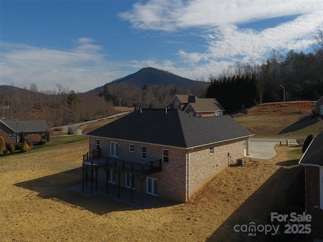 view of home's exterior featuring central AC unit and a mountain view