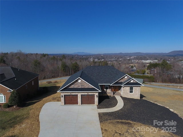 view of front of home featuring a garage and a mountain view