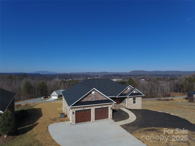 view of front of home with a garage and a mountain view