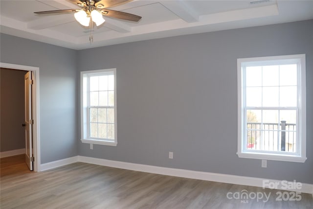 spare room featuring beamed ceiling, ceiling fan, and light hardwood / wood-style flooring