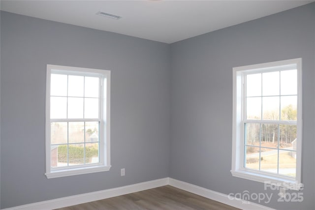 spare room with hardwood / wood-style flooring