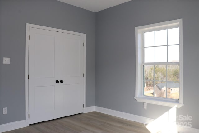 unfurnished bedroom featuring light hardwood / wood-style floors and a closet