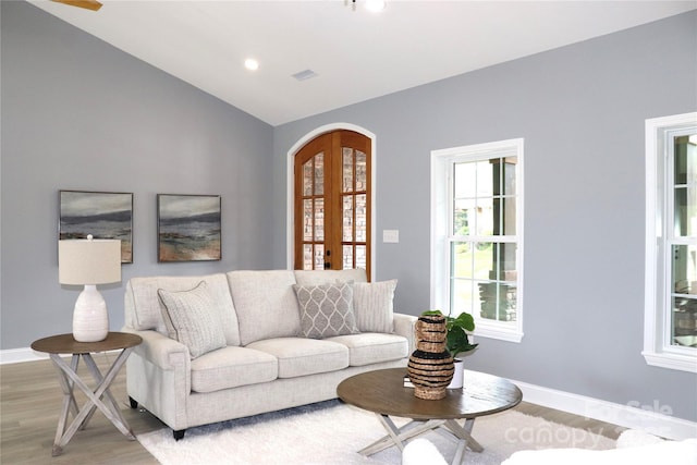 418 Huntington Woods St SE, Lenoir, NC 28645 - living room featuring french doors, light wood-style flooring, vaulted ceiling, baseboards, and arched walkways
