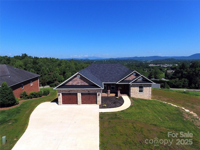 418 Huntington Woods St SE, Lenoir, NC 28645 - view of front of home with concrete driveway, a front yard, an attached garage, and stone siding