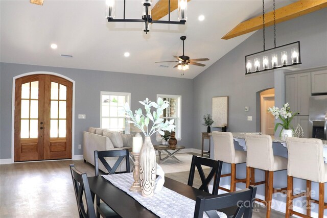 418 Huntington Woods St SE, Lenoir, NC 28645 - dining space with arched walkways, beamed ceiling, wood finished floors, high vaulted ceiling, and french doors