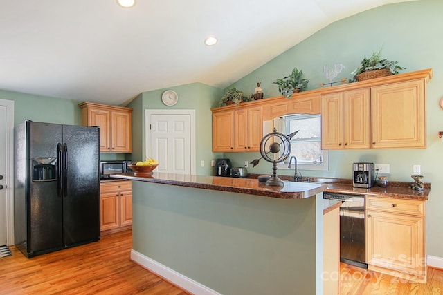 kitchen featuring beverage cooler, black appliances, a center island, light brown cabinets, and light hardwood / wood-style flooring