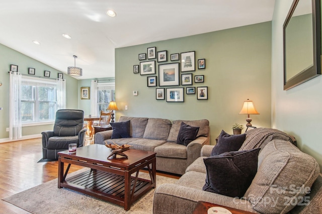 living room featuring light wood-type flooring and lofted ceiling