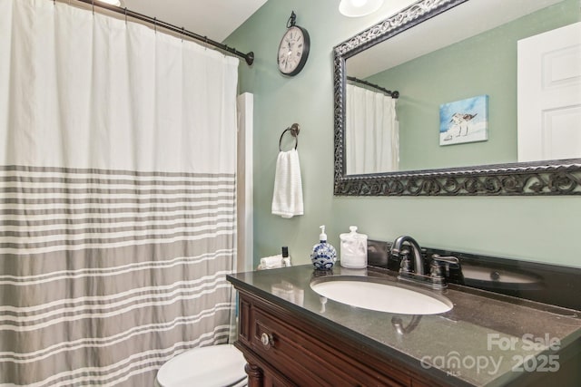 bathroom featuring toilet and vanity