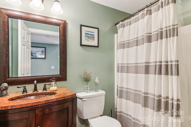 bathroom featuring toilet, a shower with curtain, and vanity