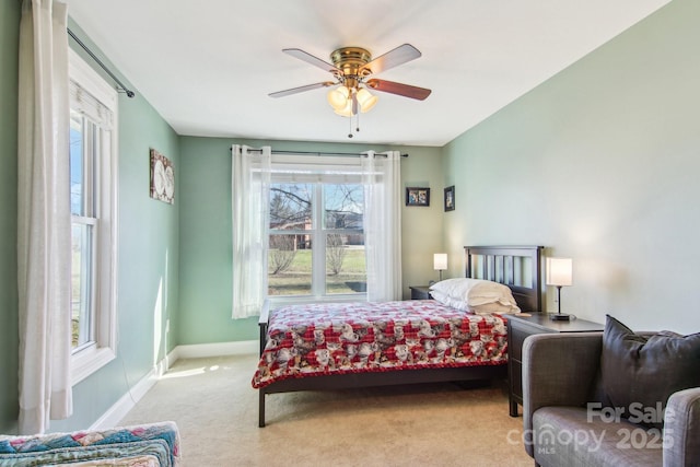 bedroom featuring ceiling fan and light colored carpet