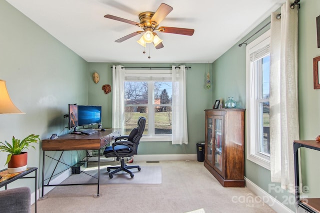 office space with ceiling fan and light colored carpet