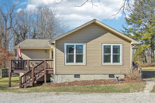 view of side of home with a deck