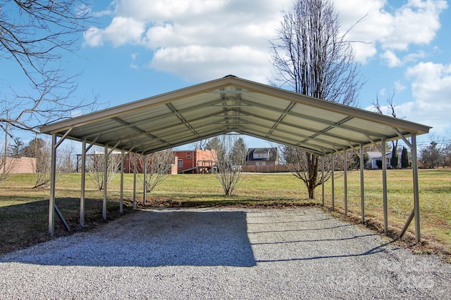 view of parking with a lawn and a carport