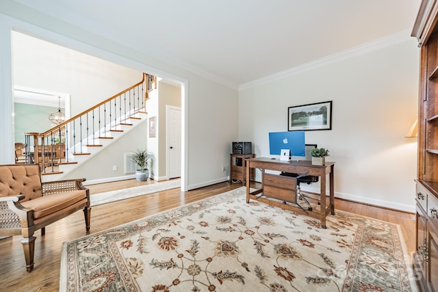 office with ornamental molding, an inviting chandelier, and light wood-type flooring