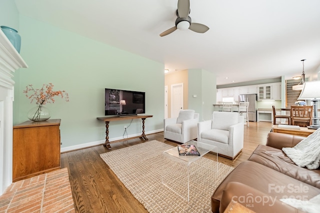 living room with ceiling fan and hardwood / wood-style floors