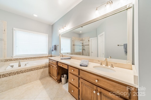 bathroom featuring tile patterned flooring, vanity, and separate shower and tub