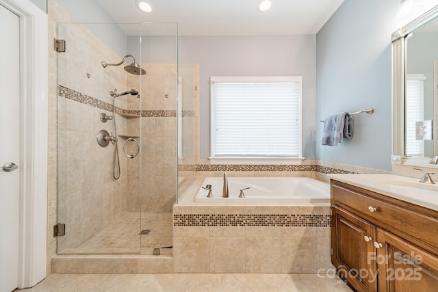 bathroom featuring tile patterned flooring, plus walk in shower, and vanity