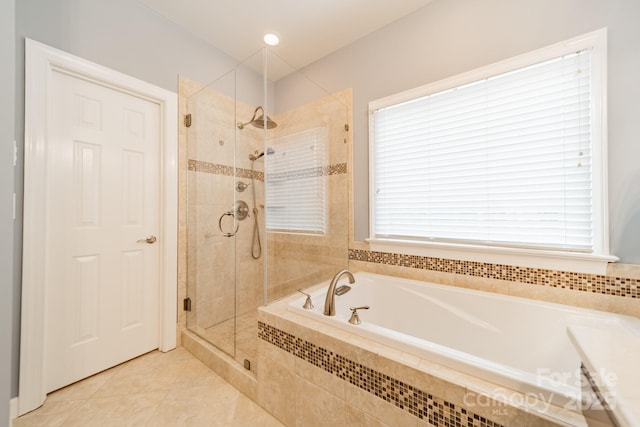 bathroom featuring tile patterned flooring, plus walk in shower, and plenty of natural light