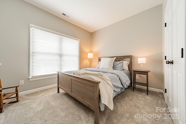 bedroom featuring vaulted ceiling and light colored carpet