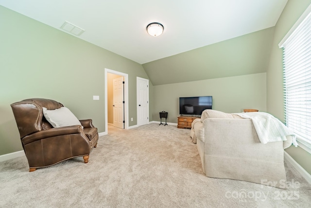 living area featuring vaulted ceiling and light carpet