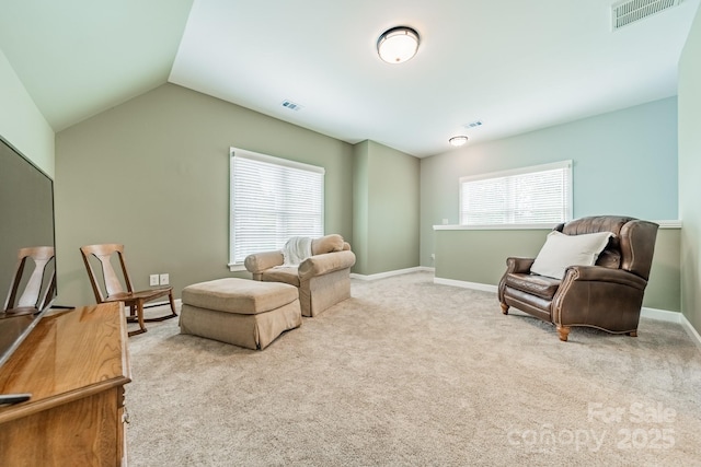 living area featuring light colored carpet and lofted ceiling