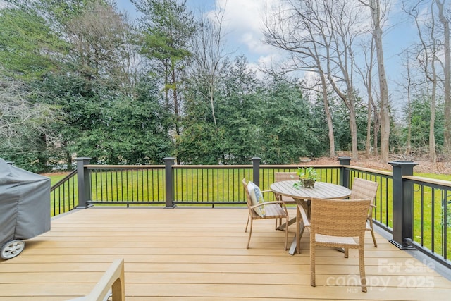 deck with area for grilling and a lawn