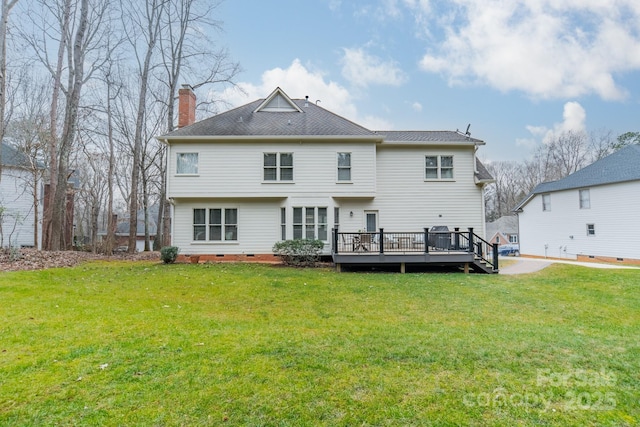 rear view of house with a yard and a deck