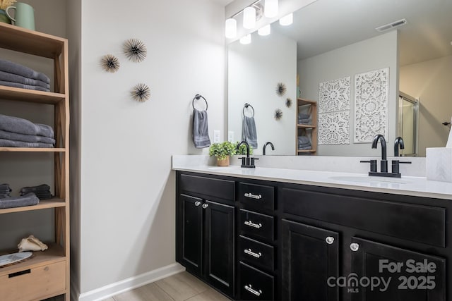 bathroom with vanity and an enclosed shower