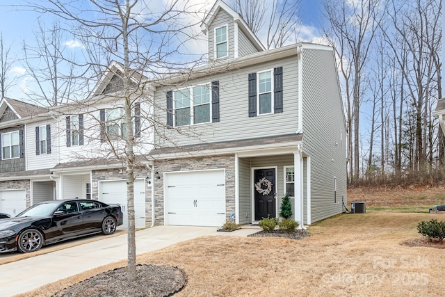 view of front of home featuring cooling unit and a garage