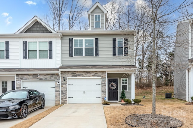 townhome / multi-family property featuring a garage and central AC