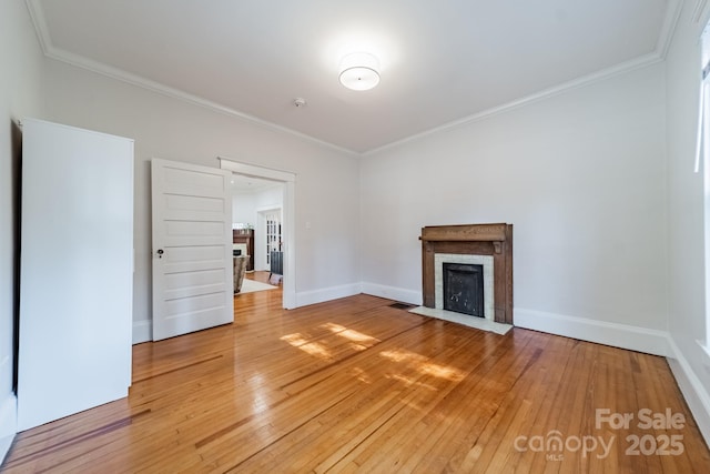 unfurnished living room featuring ornamental molding and hardwood / wood-style floors