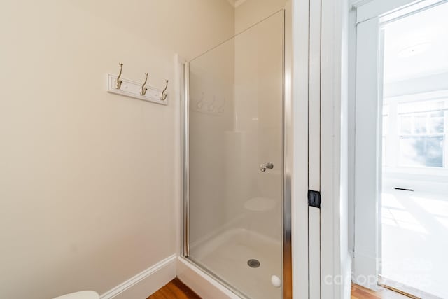 bathroom featuring hardwood / wood-style floors and a shower with door