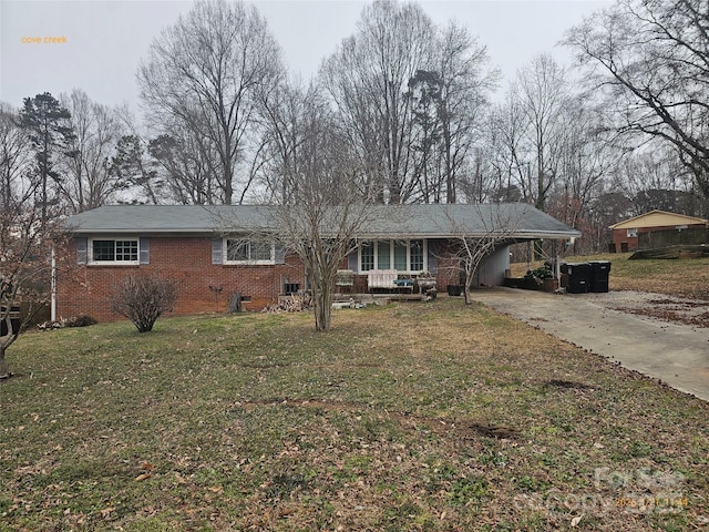 ranch-style home with a front yard and a carport