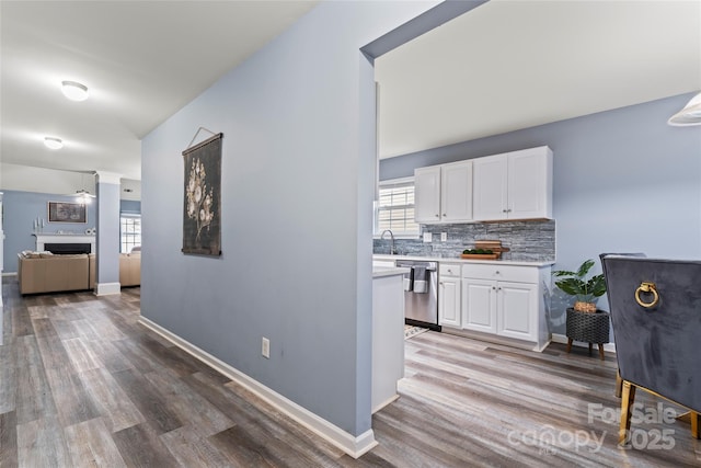 corridor featuring sink, hardwood / wood-style flooring, and a wealth of natural light