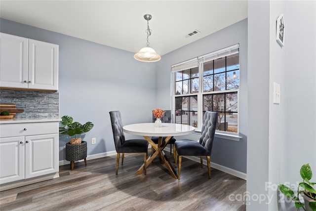 dining space with dark hardwood / wood-style floors