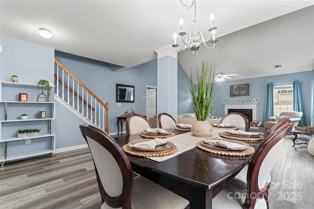 dining room featuring wood-type flooring and ceiling fan with notable chandelier