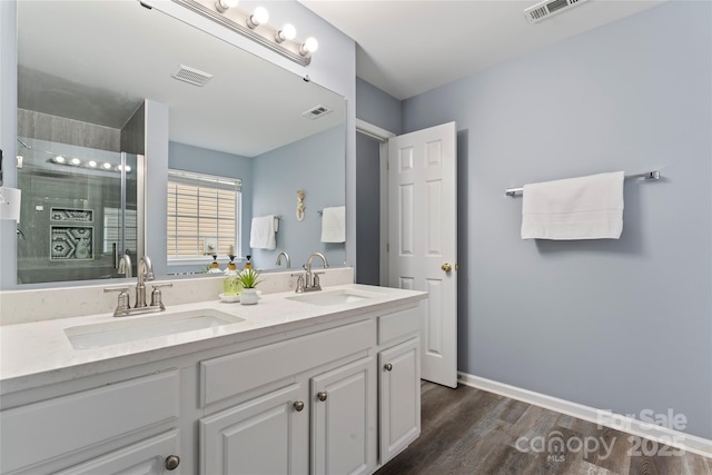 bathroom featuring vanity, hardwood / wood-style floors, and an enclosed shower