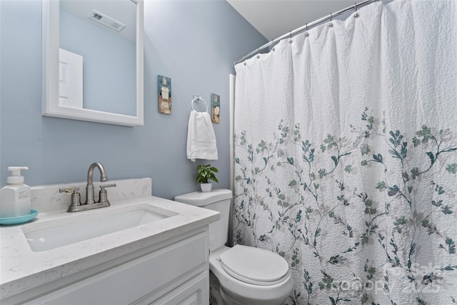 bathroom with vanity, toilet, and a shower with shower curtain